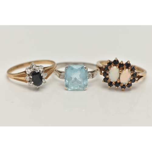 126 - THREE GEM SET RINGS, the first a 9ct yellow gold, double cluster ring, set with two oval cut opal ca... 