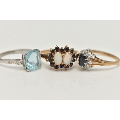 126 - THREE GEM SET RINGS, the first a 9ct yellow gold, double cluster ring, set with two oval cut opal ca... 