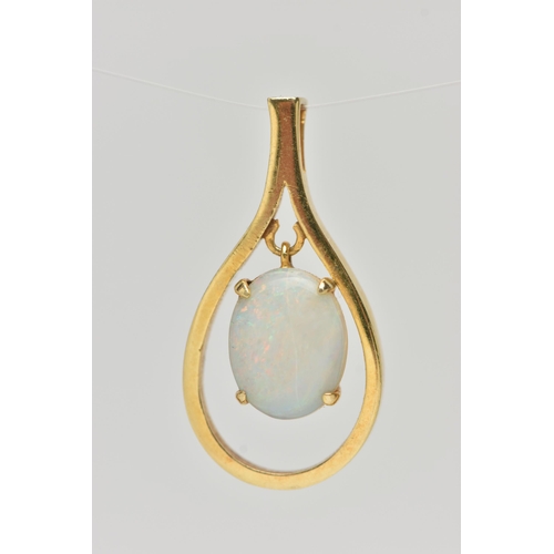 127 - A YELLOW METAL OPAL CABCOHON PENDANT, open work tear drop shape pendant, set with a central oval cut... 