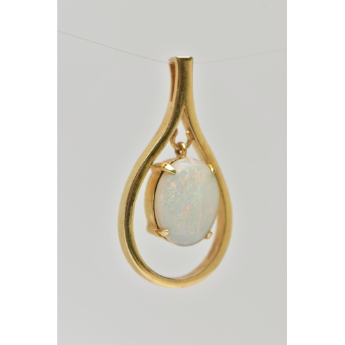 127 - A YELLOW METAL OPAL CABCOHON PENDANT, open work tear drop shape pendant, set with a central oval cut... 