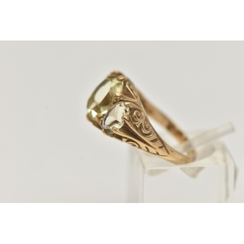 135 - A 9CT GOLD GEM SET RING, three light yellow oval cut quartz stones, prong set in yellow gold, scroll... 