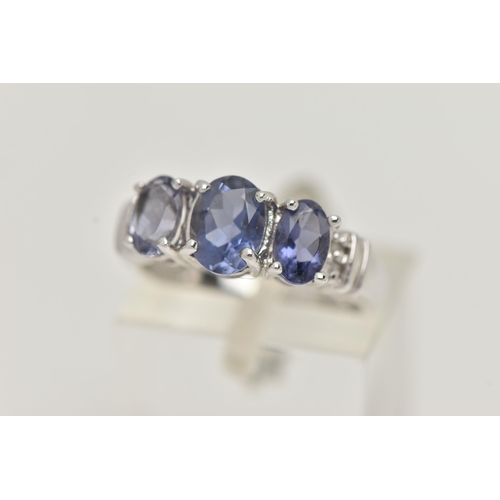 76 - A 9CT WHITE GOLD TANZANITE RING, set with three oval cut tanzanite, each in a four claw setting, wit... 