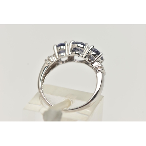 76 - A 9CT WHITE GOLD TANZANITE RING, set with three oval cut tanzanite, each in a four claw setting, wit... 