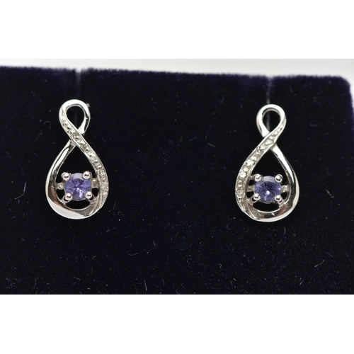 77 - A BOXED PAIR OF 9CT WHITE GOLD TANZANITE AND DIAMOND SET EARRINGS, each earring set with a small cir... 