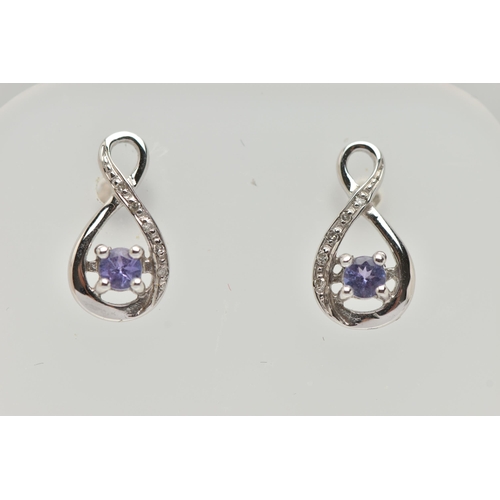 77 - A BOXED PAIR OF 9CT WHITE GOLD TANZANITE AND DIAMOND SET EARRINGS, each earring set with a small cir... 