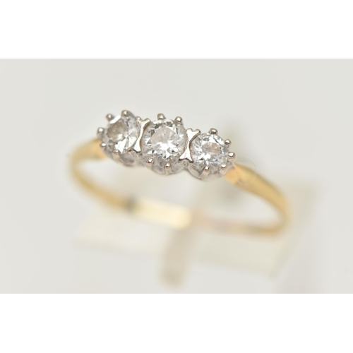 87 - A YELLOW METAL THREE STONE DIAMOND RING, three round brilliant cut diamonds, each claw set, estimate... 