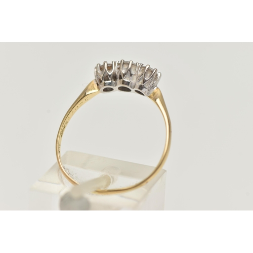 87 - A YELLOW METAL THREE STONE DIAMOND RING, three round brilliant cut diamonds, each claw set, estimate... 