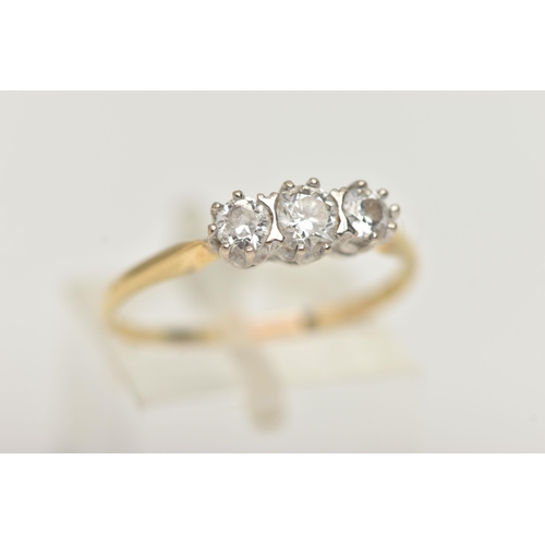 87 - A YELLOW METAL THREE STONE DIAMOND RING, three round brilliant cut diamonds, each claw set, estimate... 