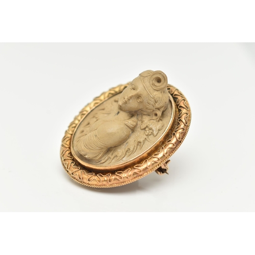 91 - A YELLOW METAL, HIGH RELIEF LAVA CAMEO BROOCH, of an oval form, depicting a lady in profile, collet ... 