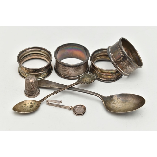 168 - AN ASSORTMENT OF SILVER ITEMS, to include four silver napkin rings, a tea spoon, a spoon a thimble a... 