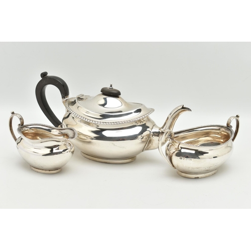 184 - A MID 20TH CENTURY, THREE PIECE SILVER TEA SET, comprising of a teapot, fitted with an ebonised hand... 