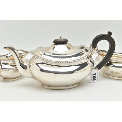 184 - A MID 20TH CENTURY, THREE PIECE SILVER TEA SET, comprising of a teapot, fitted with an ebonised hand... 