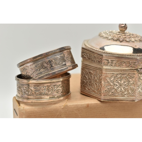 186 - SEVEN SILVER NAPKIN RINGS AND AN INDIAN TRINKET BOX, to include a set of four engine turned napkin r... 