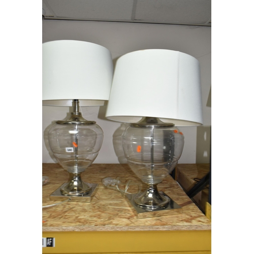 340 - TWO MODERN TABLE LAMPS, with glass bodies and cream shades, height to top of fitting approximately 5... 