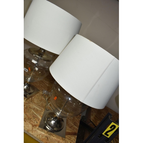 340 - TWO MODERN TABLE LAMPS, with glass bodies and cream shades, height to top of fitting approximately 5... 