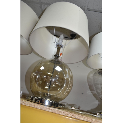 341 - TWO MODERN TABLE LAMPS, with glass bodies and wheat coloured shades, height to top of fitting approx... 