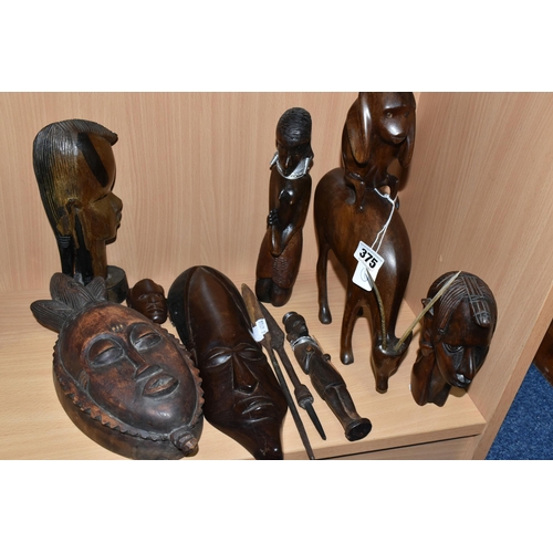 375 - A GROUP OF CARVED HARDWOOD TRIBAL FIGURES, comprising ten carved wooden souvenir figures of animals,... 