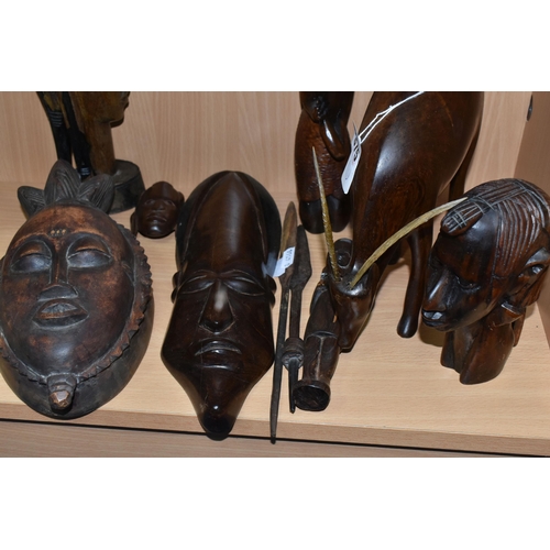 375 - A GROUP OF CARVED HARDWOOD TRIBAL FIGURES, comprising ten carved wooden souvenir figures of animals,... 