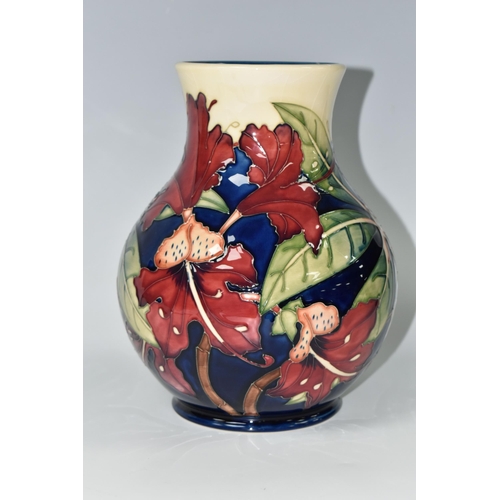 384 - A MOORCROFT POTTERY 'SIMEON' BALUSTER VASE, tubelined with red flowers on a blue and cream ground, i... 