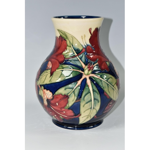 384 - A MOORCROFT POTTERY 'SIMEON' BALUSTER VASE, tubelined with red flowers on a blue and cream ground, i... 