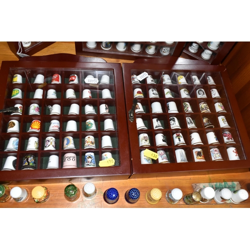 436 - A COLLECTION OF  THIMBLES, comprising seven wooden display cabinets and approximately four hundred a... 