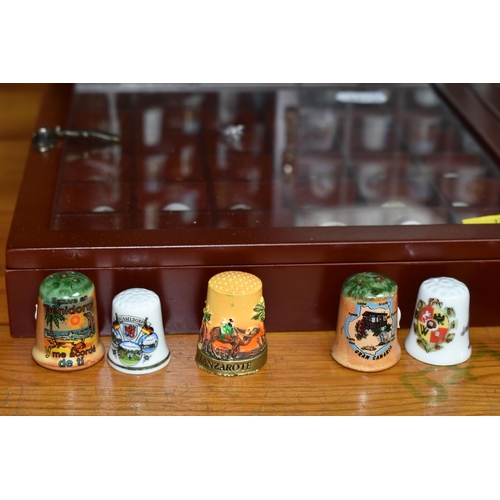 436 - A COLLECTION OF  THIMBLES, comprising seven wooden display cabinets and approximately four hundred a... 