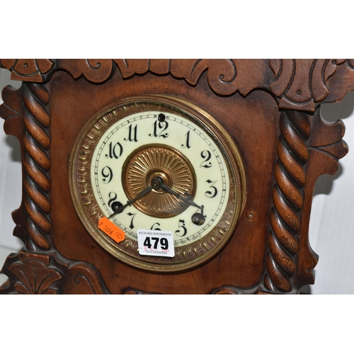 479 - A AMERICAN MANTEL CLOCK, made by The Ansonia Clock Company - New York, a stained pine gingerbread ty... 