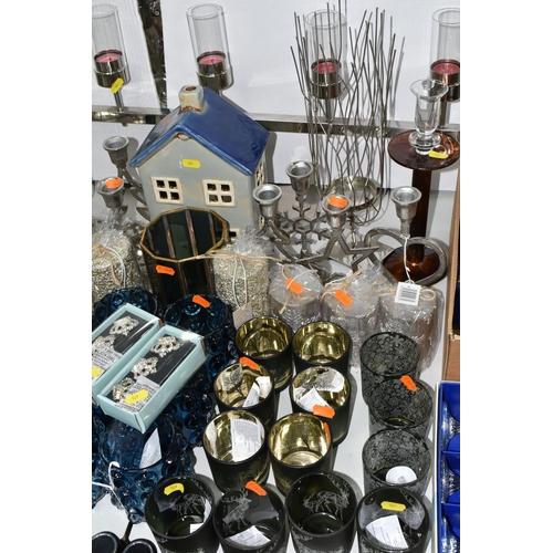 527 - A COLLECTION OF CANDLE HOLDERS AND CANDLES ETC, to include a modernist style candelabra holding six ... 