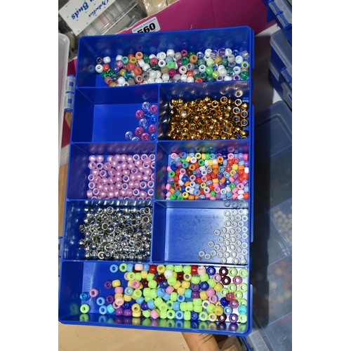 560 - TWO BOXES AND LOOSE GLASS AND PLASTIC BEADS AND BEADING LOOM, to include twelve plastic storage cont... 