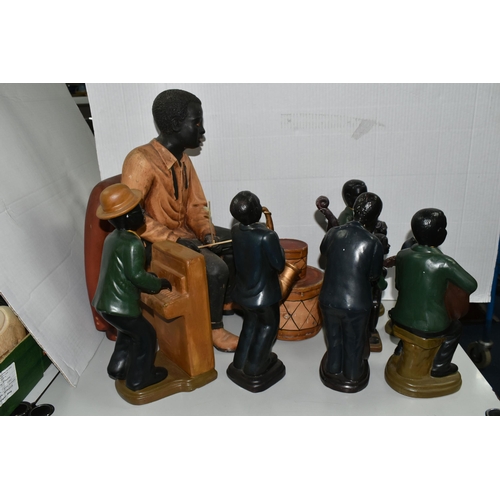 565 - A GROUP OF EIGHT CERAMIC JAZZ MUSICIANS, comprising bass player, trumpet player, two guitarists (one... 