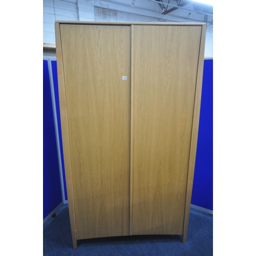 1200 - AN ERCOL SAVONA OAK TWO DOOR WARDROBE, enclosing an internal mirror to the right door, and a shelf, ... 