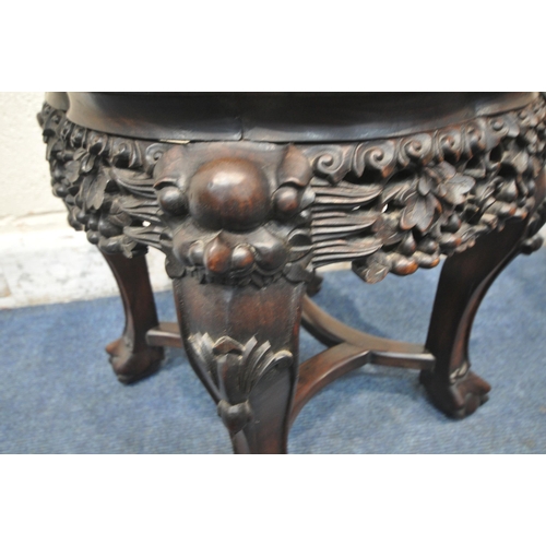 1208 - TWO CHINESE HARDWOOD SIDE TABLES, each with a pink marble insert, intricate carved details to apron ... 