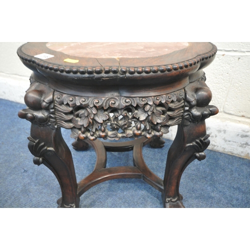 1208 - TWO CHINESE HARDWOOD SIDE TABLES, each with a pink marble insert, intricate carved details to apron ... 