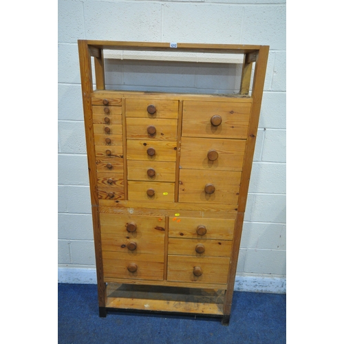 1212 - A 20TH CENTURY PINE APOTHECARY CABINET, with an arrangement of twenty-three drawers, the top section... 