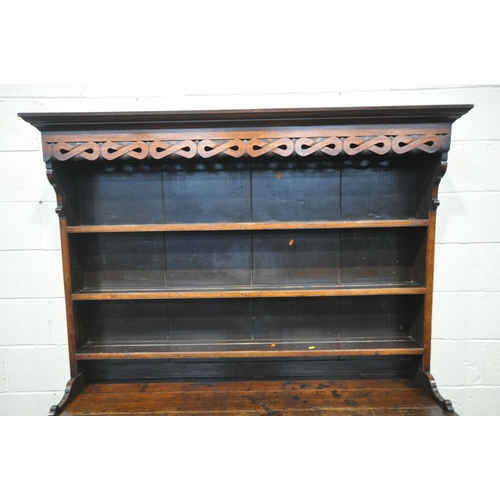 1220 - A GEORGIAN OAK BREAKFRONT DRESSER, the top three tier plate rack, with repeating infinity details, a... 