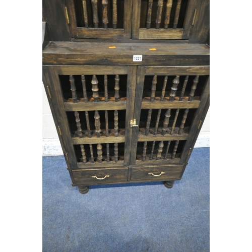 1221 - A 20TH CENTURY OAK CABINET, with raised gallery, drop finials, two spindled small doors, above two l... 