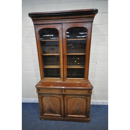 1238 - A 19TH CENTURY MAHOGANY BOOKCASE, the top with double glazed doors, that's enclosing three shelves, ... 