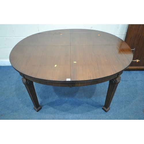 1264 - AN EARLY 20TH CENTURY MAHOGANY OVAL WIND OUT DINING TABLE, with two additional leaves, on square tap... 