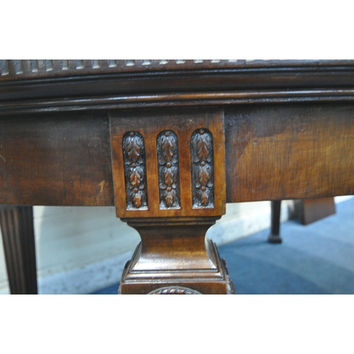 1264 - AN EARLY 20TH CENTURY MAHOGANY OVAL WIND OUT DINING TABLE, with two additional leaves, on square tap... 