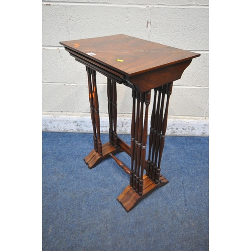 1265 - AN EARLY 20TH CENTURY FLAME MAHOGANY QUARTETTO NEST OF FOUR TABLES, raised on turned supports, shape... 