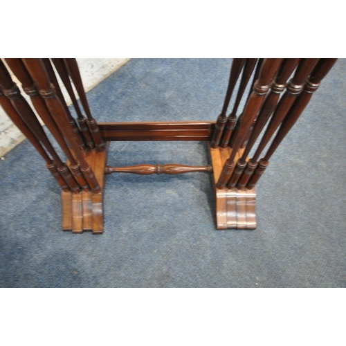 1265 - AN EARLY 20TH CENTURY FLAME MAHOGANY QUARTETTO NEST OF FOUR TABLES, raised on turned supports, shape... 