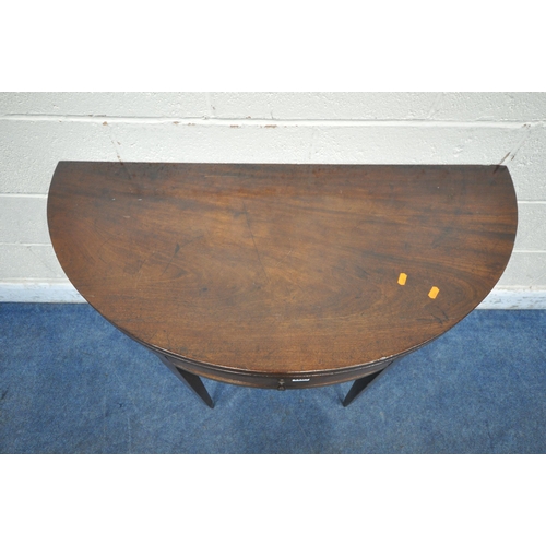 1269 - A GEORGIAN MAHOGANY DEMI-LUNE FOLD OVER TEA TABLE, with a single frieze drawer, raised on square tap... 