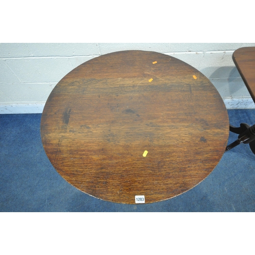 1283 - A GEORGIAN STYLE OAK CIRCULAR TRIPOD TABLE, raised on a turned support with spiral detail and three ... 