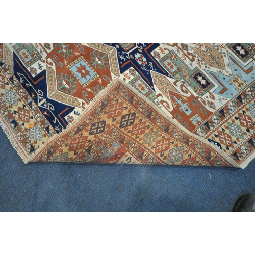 1288 - A PERSIAN WOOLEN RUG, with multi-coloured repeating geometric patterns and a multi-strap border, 217... 