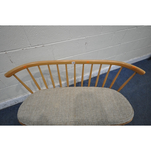 1290 - LUCIAN ERCOLANI, ERCOL, A MID CENTURY ELM AND BEECH DINING LOVE SEAT, with bentwood and spindle back... 