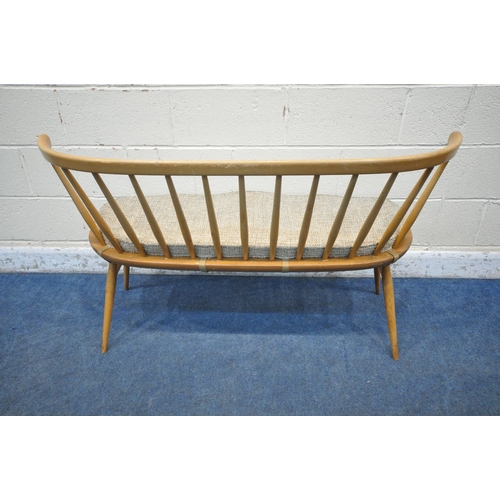 1290 - LUCIAN ERCOLANI, ERCOL, A MID CENTURY ELM AND BEECH DINING LOVE SEAT, with bentwood and spindle back... 