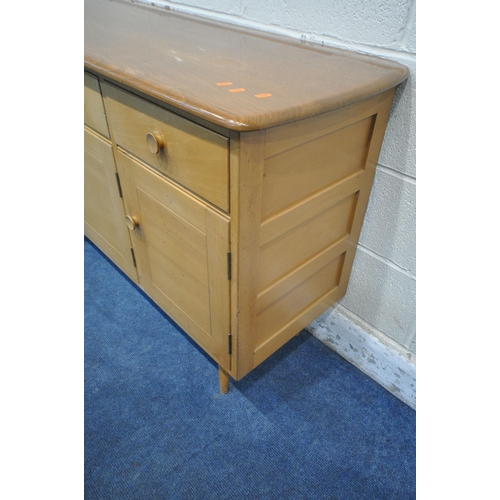 1292 - LUCIAN ERCOLANI, ERCOL, A MID CENTURY ELM AND BEECH SIDEBOARD, fitted with two drawers, above three ... 