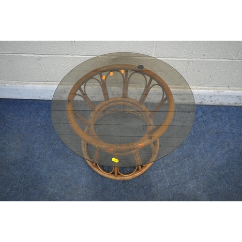 1297 - A COZY BAY RATTAN ARMCHAIR, along with a circular smoked glass table (condition report: general sign... 