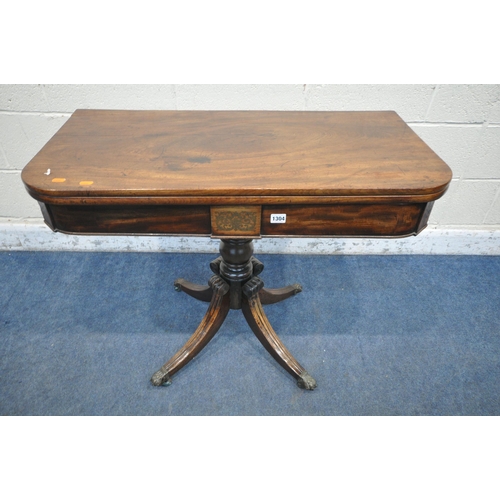 1304 - A REGENCY MAHOGANY FOLD OVER TEA TABLE, the revolving fold over top, enclosing a small storage compa... 