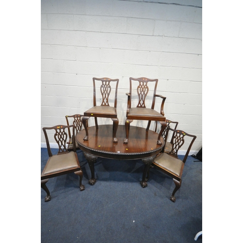 1307 - AN EARLY 2OTH CENTURY MAHOGANY OVAL WIND OUT DINING TABLE, the legs with scrolled and foliate detail... 